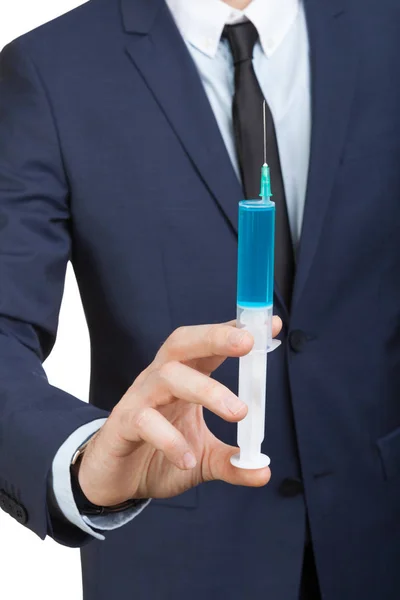 Businessman holding big syringe as a symbol of pharmaceutical industry — Stock Photo, Image