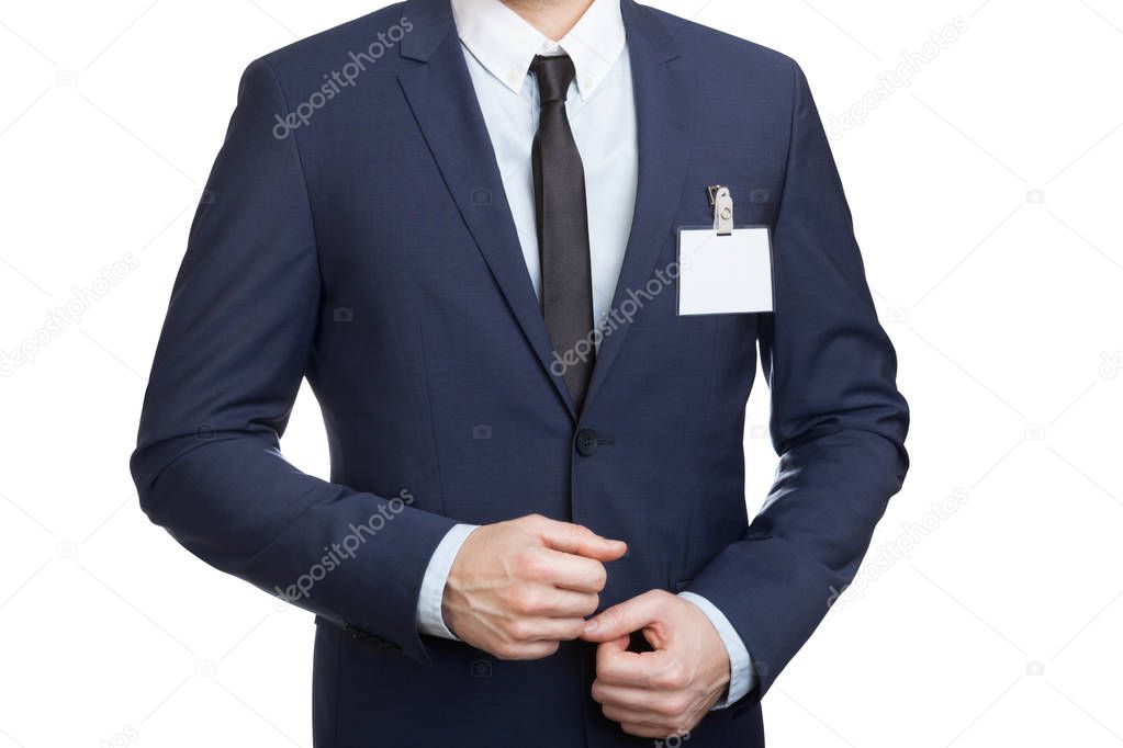 Businessman wearing a blank ID tag or name card at an exhibition or conference