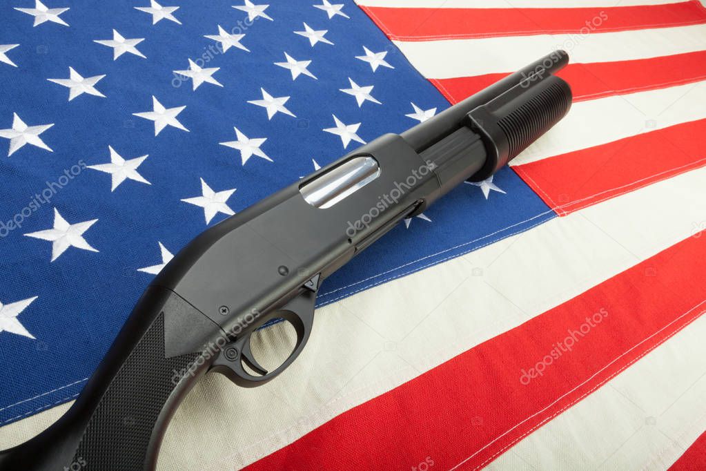 Shotgun without any lables on USA flag as a symbol of second amendment