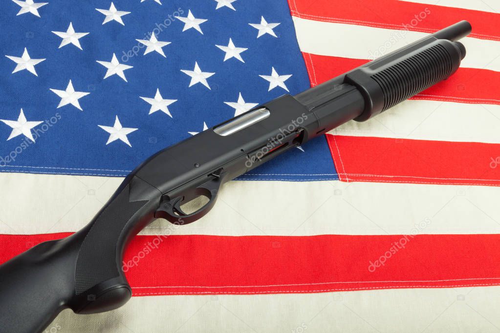 Shotgun over USA flag as a symbol of second amendment