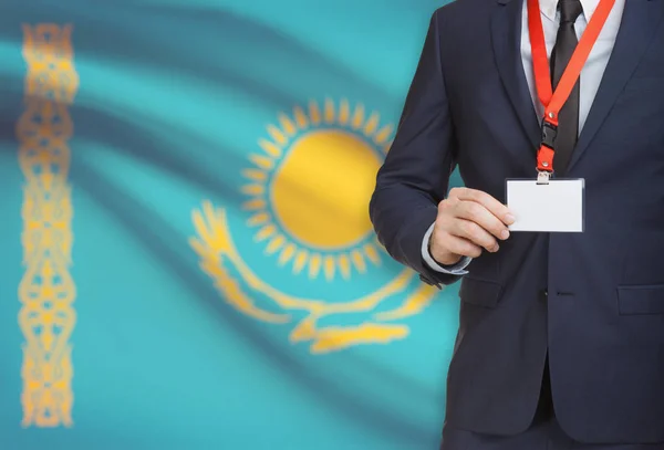 Businessman holding name card badge on a lanyard with a national flag on background - Kazakhstan – stockfoto