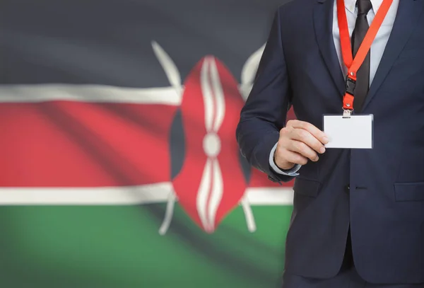 Homme d’affaires détenant des porte-nom carte sur une longe munie d’un drapeau national sur fond - Kenya — Photo