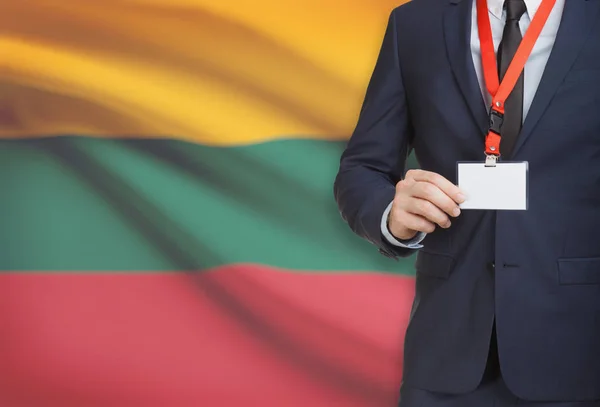 Businessman holding name card badge on a lanyard with a national flag on background - Lithuania — Stock Photo, Image