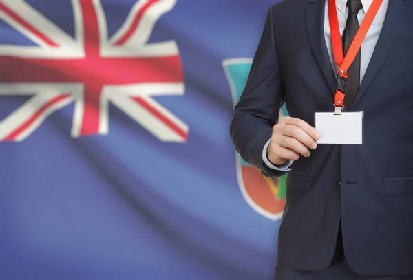 사업 배경-몬세라트에 국기와 끈 이름 카드 배지를 들고 — 스톡 사진