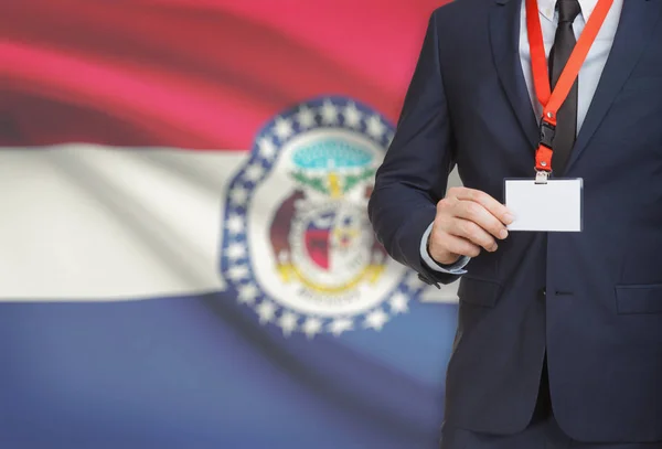 Businessman holding badge on a lanyard with USA state flag on background - Missouri — Stock Photo, Image