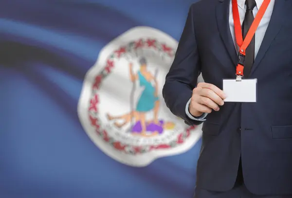 Businessman holding badge on a lanyard with USA state flag on background - Virginia — Stock Photo, Image