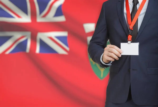 Distintivo de exploração do empresário em uma corda com a bandeira da província canadense em fundo - Ontário — Fotografia de Stock