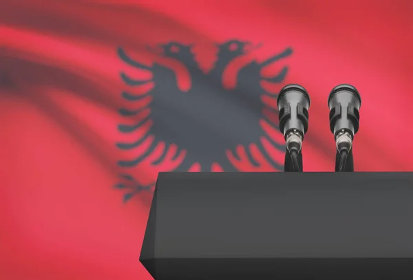 Púlpito y dos micrófonos con una bandera nacional de fondo - Albania —  Fotos de Stock