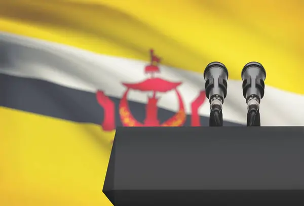 Balcon avant et deux microphones avec un drapeau national sur fond - Brunei — Photo