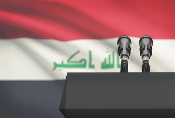 Pulpit and two microphones with a national flag on background - Iraq — Stock Photo, Image