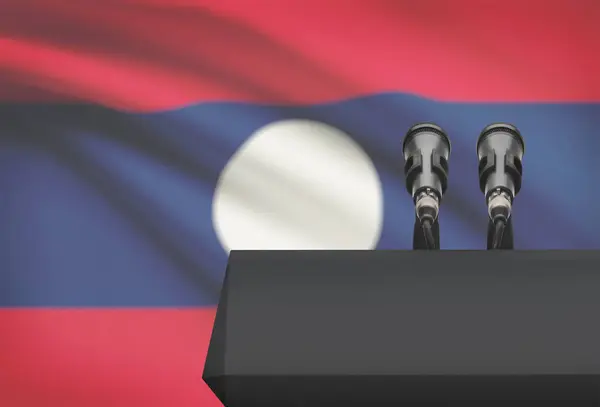Kanzel und zwei Mikrofone mit einer Nationalflagge auf Hintergrund - Laos — Stockfoto