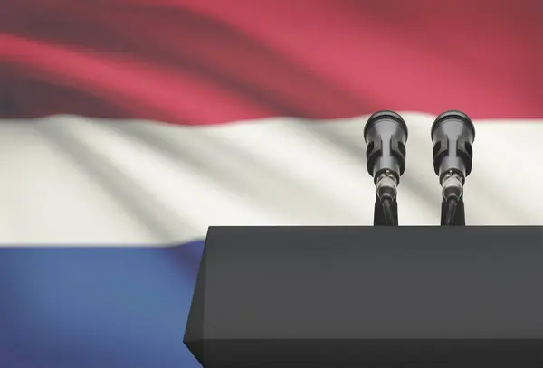 Амвон и два микрофона с флагом на фоне - Нидерланды — стоковое фото