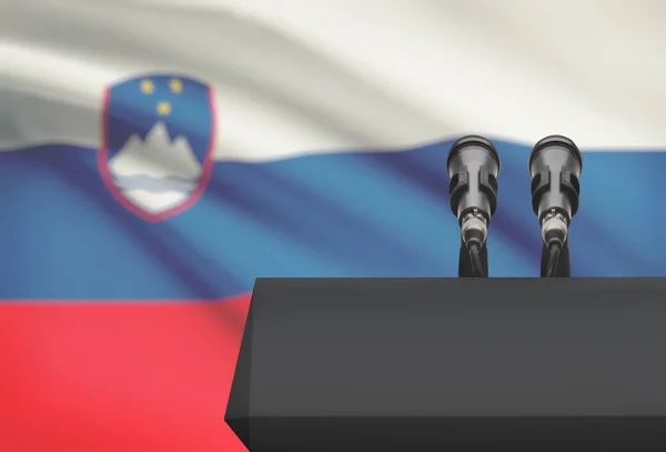 Preekstoel en twee microfoons met een nationale vlag op de achtergrond - Slovenië — Stockfoto