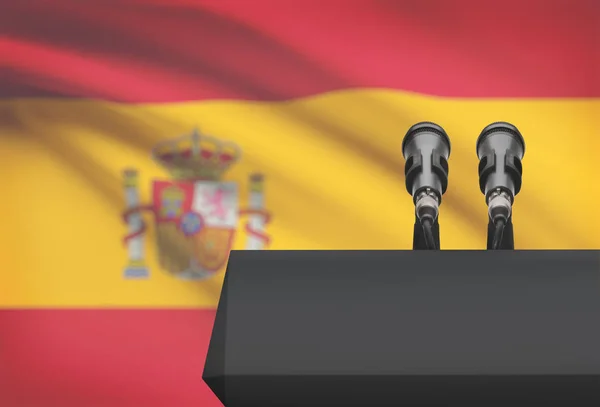 Pulpit and two microphones with a national flag on background - Spain — Stock Photo, Image