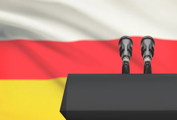 Preekstoel en twee microfoons met een nationale vlag op de achtergrond - Zuid-Ossetië — Stockfoto