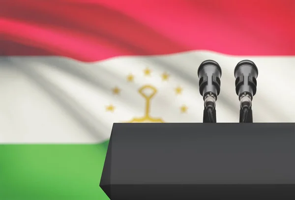 Амвон и два микрофона с флагом на фоне - Таджикистан — стоковое фото