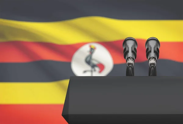 Kanzel und zwei Mikrofone mit einer Nationalflagge auf Hintergrund - Uganda — Stockfoto