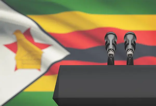 Pulpit and two microphones with a national flag on background - Zimbabwe — Stock Photo, Image