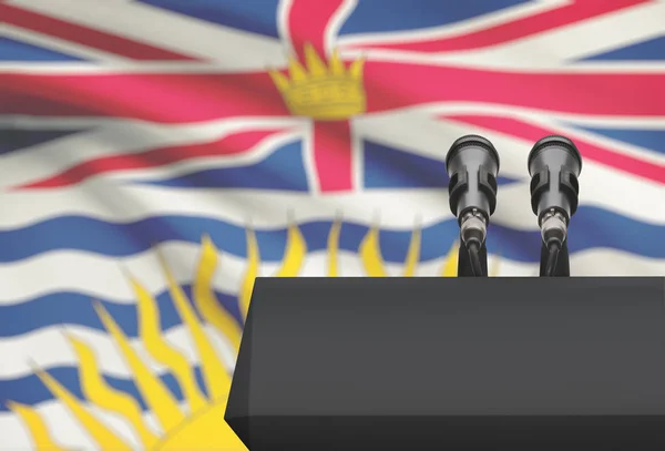 Кафедри і два мікрофони з канадської провінції прапор на фоні - Британської Колумбії — стокове фото