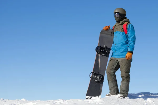 男性的滑雪板顶部的山与蓝蓝的天空背景上看风景 — 图库照片