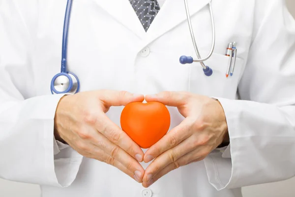 Orvostudomány és egészségügy - orvos játék szív két kezével tartja — Stock Fotó