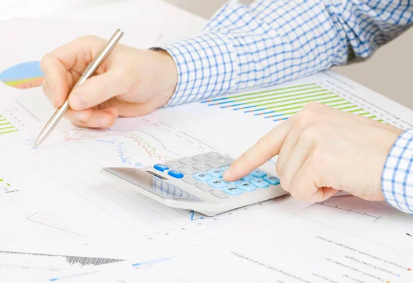 Banking, taxing and all things related with world of finance - businessman busy with some calculations at the desk Stock Picture