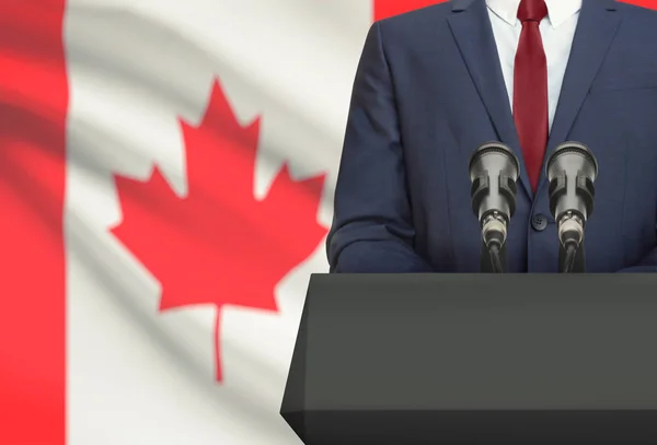 Podnikatel nebo politik, že projev zpoza kazatelna s státní vlajka na pozadí - Kanada — Stock fotografie