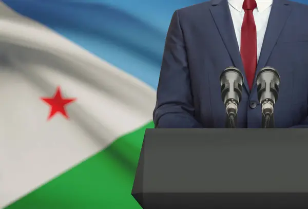 Businessman or politician making speech from behind a pulpit with national flag on background - Djibouti — Fotografia de Stock