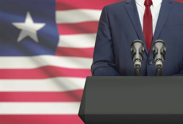 Businessman or politician making speech from behind a pulpit with national flag on background - Liberia — Fotografia de Stock