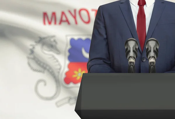 Businessman or politician making speech from behind a pulpit with national flag on background - Mayotte — Stock Photo, Image