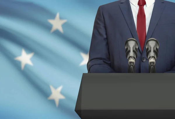 Businessman or politician making speech from behind a pulpit with national flag on background - Micronesia — Fotografia de Stock