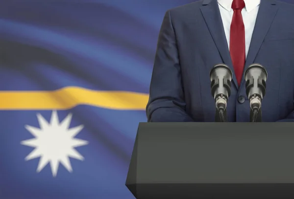 Businessman or politician making speech from behind a pulpit with national flag on background - Nauru — Stock Photo, Image