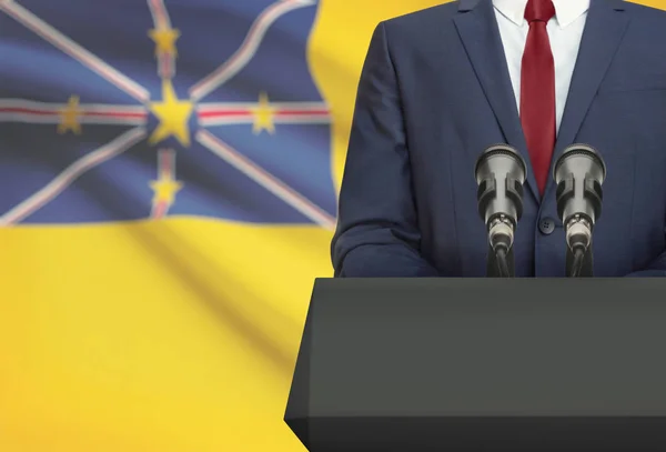 Businessman or politician making speech from behind a pulpit with national flag on background - Niue — Fotografia de Stock