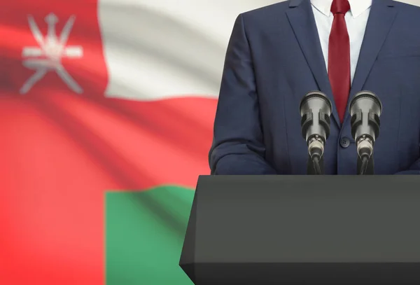 Biznesmen i polityk, Dokonywanie mowy zza ambony z flagi narodowej na tle - Oman — Zdjęcie stockowe