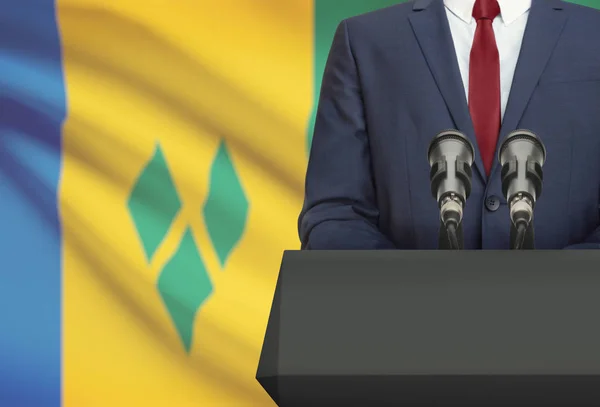 Businessman or politician making speech from behind a pulpit with national flag on background - Saint Vincent and the Grenadines — Stock Photo, Image