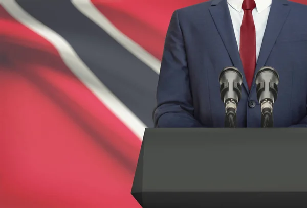 Businessman or politician making speech from behind a pulpit with national flag on background - Trinidad and Tobago — Stock Photo, Image