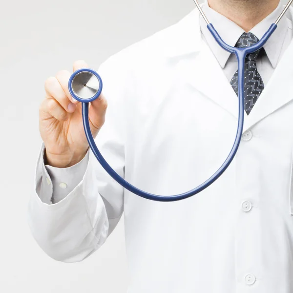 Medicine, healthcare and all things related - close up shot of medical doctor holding stethoscope in hand — Stock Photo, Image