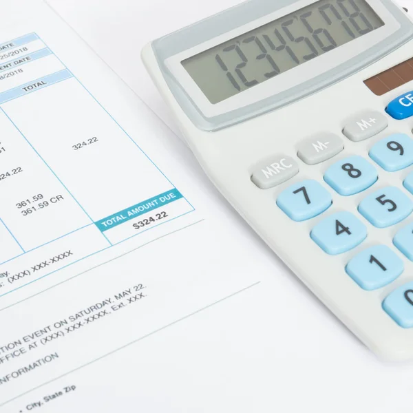 Close up shot of unpaid utility bill and calculator over it — Stock Photo, Image