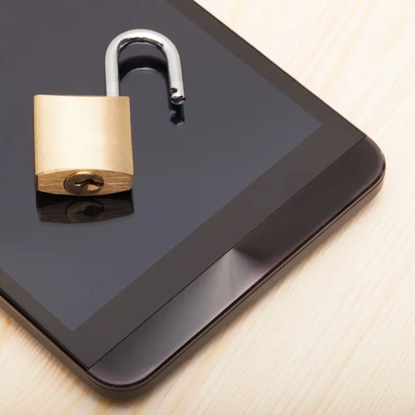 Smartphone with a small lock on it - close up shot. Mobile phone security and data protection concept — Stock Photo, Image