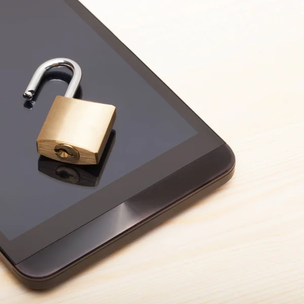 Mobile phone security and data protection concept. Smartphone with a small unlocked lock - close up shot — Stock Photo, Image