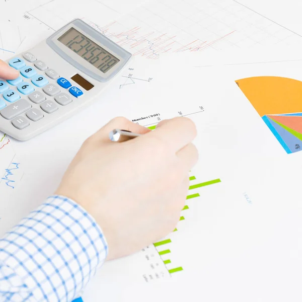 Business world and its symbols - business man busy doing some calculations at the desk — Stock Photo, Image