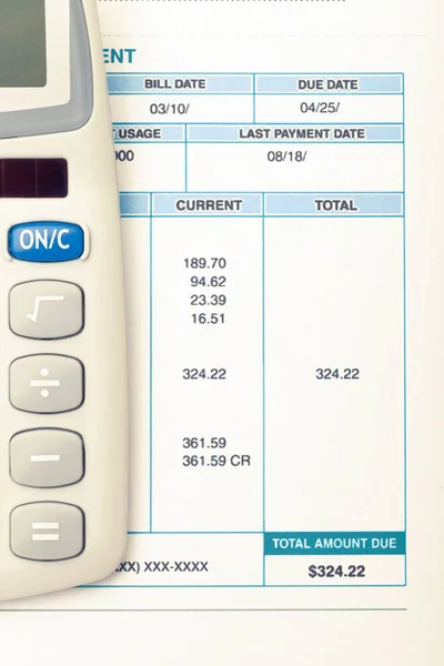 Neat calculator and utility bill next to it. Filtered image: cross processed vintage effect. — Stock Photo, Image