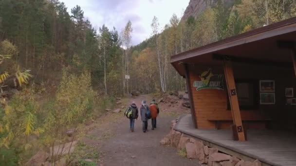 Krasnoyarsk, Rússia - 1 de novembro de 2019: Entrada oriental para a reserva natural siberiana Stolby. Turistas caminham ao longo da trilha no Parque Nacional . — Vídeo de Stock