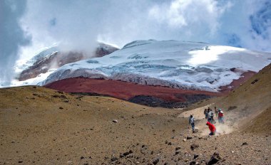 People running down the slopes of the Cotopaxi volcano, on a sunny and cloudy afternoon. Cotopaxi National Park, Ecuador. clipart