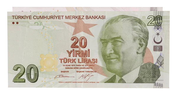 Ön tarafta 20 Türk lirası, arka planda başka madeni paralar