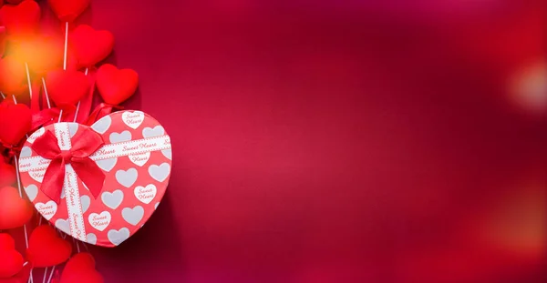 Gift box on red cloth. Red striped hearts — 스톡 사진