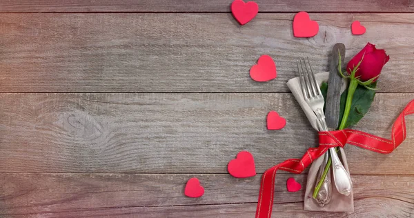 Retro cutlery and rose on old wooden table — ストック写真