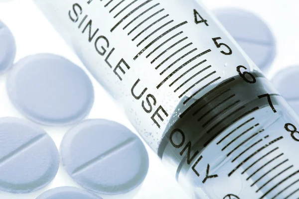 Pills and syringe on the white background — Stock Photo, Image