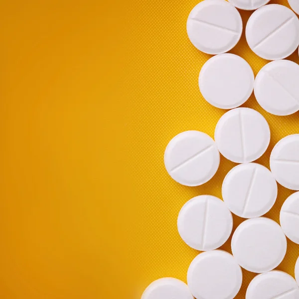 Pills on the yellow background — Stock Photo, Image