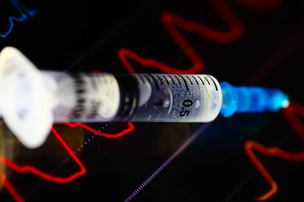 Syringe on the medical monitor — Stock Photo, Image